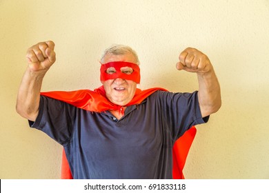 Old Man Dressed As Mature Superhero Raising Fists