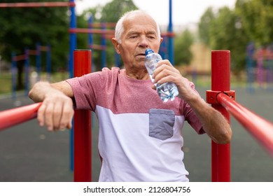 Old Man Drinking Water In Outdoor Workout