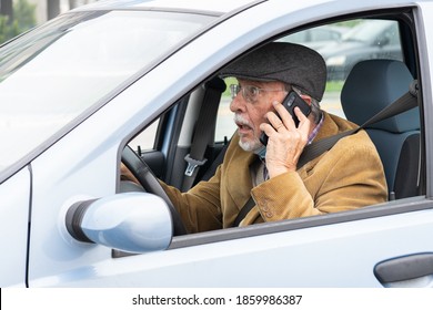 Old Man Drives His Car While Talking On Mobile Phone. Dangerous Driving On The Road