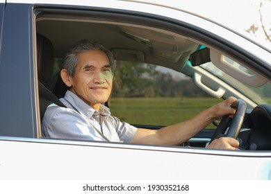 An Old Man Driving A Car                              