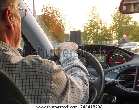 OLD MAN DRIVING A CAR
