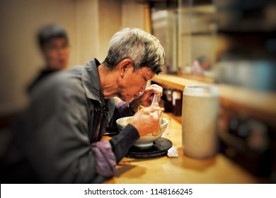 Old Man Eating The Ramen With Hot Soup. Delicious Japanese Food.