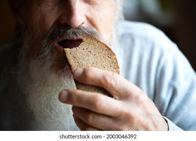 An Old Man Eats Bread, Face And Mouth Close Up