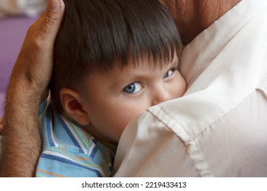 Old Man Embracing Little Boy. Grandfather Giving A Warm Hug To Grandchild At Home. Child Feeling Relieved. 