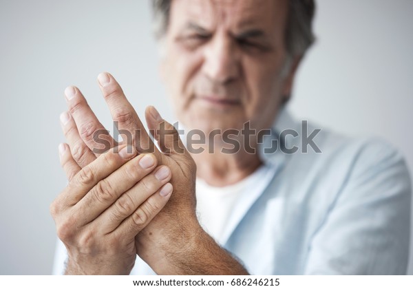 Old man with finger\
pain