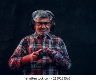 Old Man Gamer With Joystick Against Dark Background