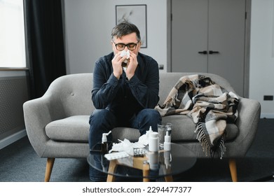 old man get a cold and sneeze with tissue paper at home. - Powered by Shutterstock