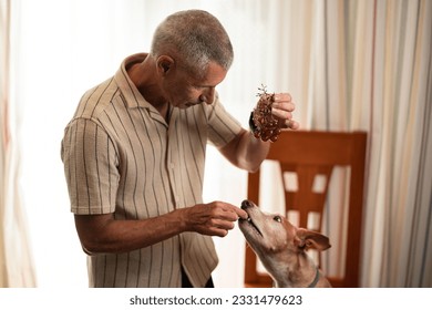 Old man giving grapes to his dog - Powered by Shutterstock