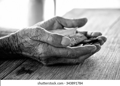 old man hand begging for money. because of the hunger