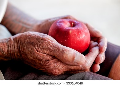 The Old Man Hand Holding Apple 