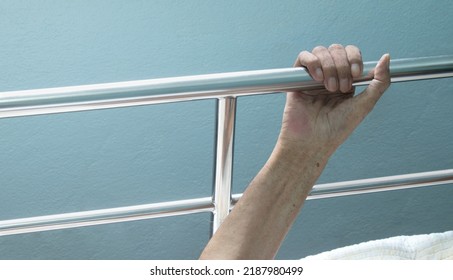 Old man hand on the edge of the patient's bed. Elderly man is waiting for help. Elderly, Aging concept - Shutterstock ID 2187980499