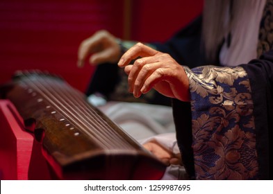 Old Man Hand Is Playing Vintage Chinese Music Instrument Indoor By Expert Skill