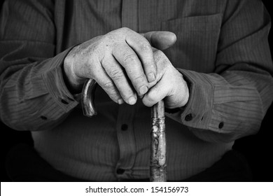 Old Man Hand's On Wood Cane In Black And White