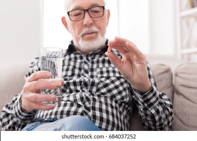 Old Man Having A Glass Of Water And Pills In Hand. Healthcare, Treatment, Aging Concept