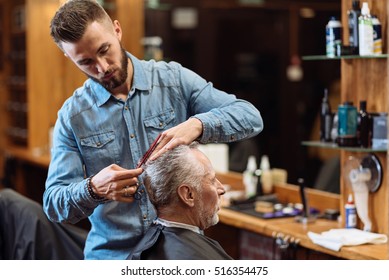 Old Man Having Haircut By Young Specialist