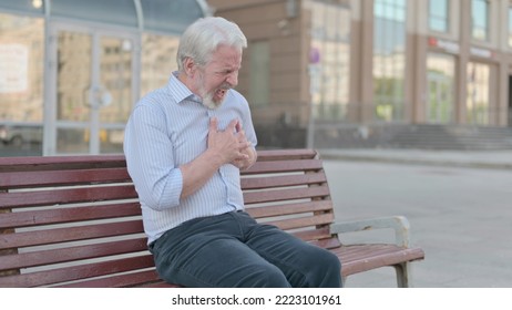 Old Man having Heart Pain while Sitting on Bench Outdoor - Shutterstock ID 2223101961