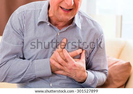 Old man holding breast because of heart infarction 