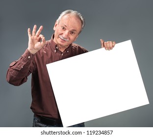 Old Man Holding Empty Billboard And Shows Sign OK