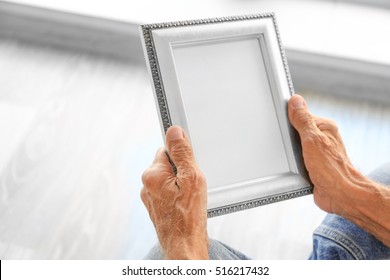 Old Man Holding Photo Frame