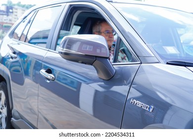 Old Man Inside A Hybrid Car. Automatic And Electric Car.