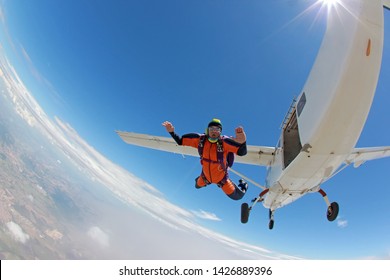 An old man jumping scared from the plane.