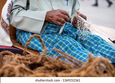 Old Man Is Knitting Traditional Fishing Net, Hands In Frame