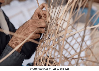 Old man is knitting weaving traditional basket from palm leaves, hands in frame. High quality photo. - Powered by Shutterstock