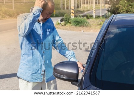 The old man left the car keys in the car, accidentally locking the keys inside the car.