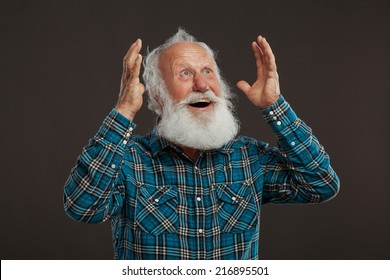 Old Man With A Long Beard With Big Smile On A Dark Background