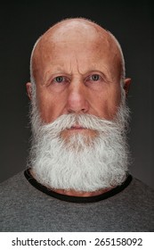 Old Man With A Long Beard With Big Smile On A Dark Background