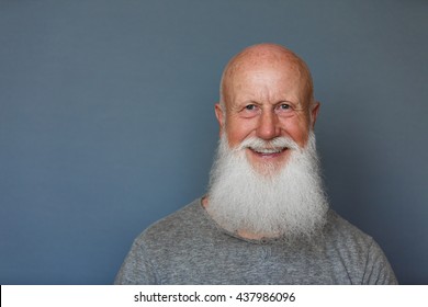 Old Man With A Long Beard With Big Smile On A Blue Background