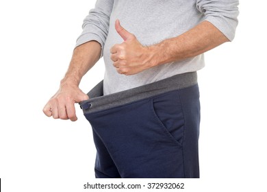 old man looking in his pants and showing thumbs up