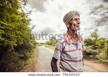 Old man looking at the sky on nature background.
