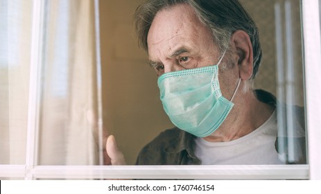 Old Man Looking Through The Window And Waving Hand With Mask Protection