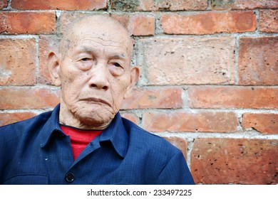 An Old Man Looks At The Camera.