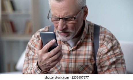 Old Man Looks Incredulously At Cellphone, New Technology Complicated For Elderly