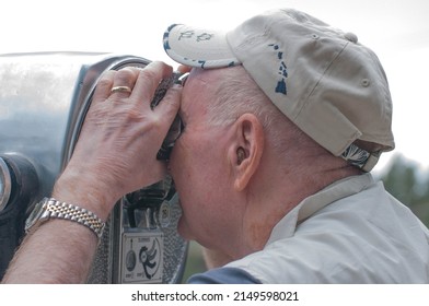 Old Man Looks Through Binoculars