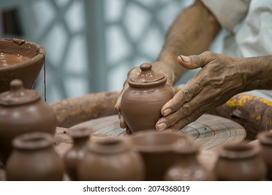 An old man making clay pots