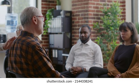 Old Man Making Confession About Alcoholism And Depression In Front Of People At Aa Group Therapy. Senior Person Sharing Addiction Story At Rehabiliation Meeting To Cure Problems.