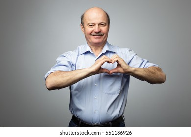 Old Man Making Out Of Hands Heart. Doing Charity Work, Take Care Of The Health, Or Being In Love