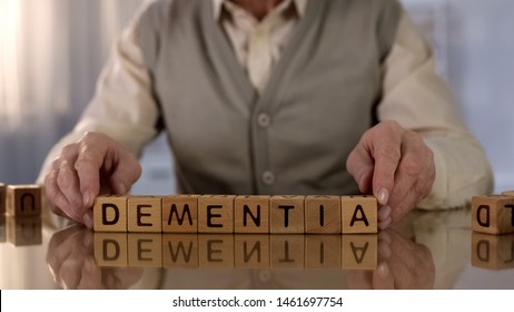 Old Man Making Word Dementia Of Wooden Cubes On Table, Brain Disease, Health