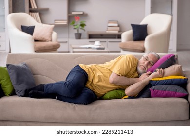 Old man with many pillows at home - Powered by Shutterstock