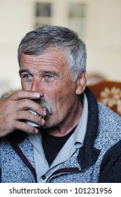 Old Man With Mustache Drinking Traditional Coffee