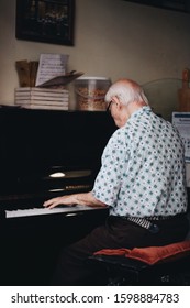 Old Man On His Back Playing Piano