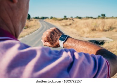 An Old Man On The Street Wearing A Smart Watch. Healthy Living Concept