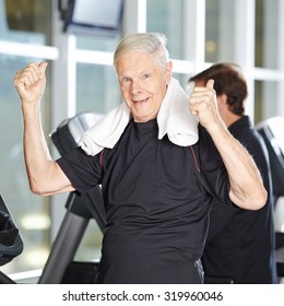 Old Man On Treadmill In Fitness Center Holding His Thumbs Up