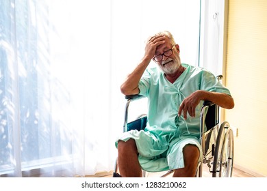 A Old Man Or Patient Or Elder Lonely Sitting On Wheel Chair In Hospital