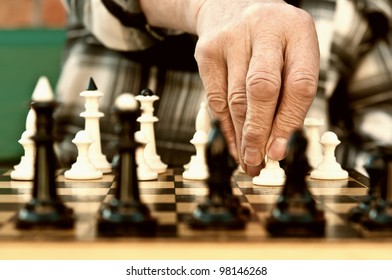 Old Man Playing Chess And Make The First Move