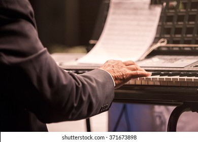 Old Man Playing Piano On Stage