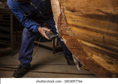 Old Man Polishing The Keel Of A Traditional Boat He Is Building